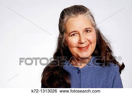Stock Photograph - Senior woman looking at camera and smiling. Fotosearch