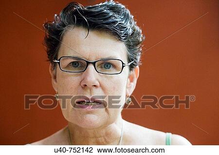 Stock Image - Senior woman making faces. Fotosearch
