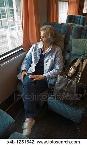 Stock Image - Senior woman on train Finland Europe. Fotosearch