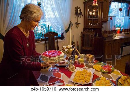 Senior woman preparing a table for a party View Large Photo Image Stock Photograph - Senior woman preparing a table for a party. Fotosearch