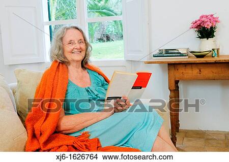Picture - Senior woman reading a book. Fotosearch