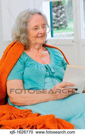 Senior woman reading a book View Large Photo Image Stock Image - Senior woman reading a book. Fotosearch