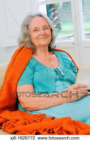 Senior woman reading a book View Large Photo Image Stock Image - Senior woman reading a book. Fotosearch