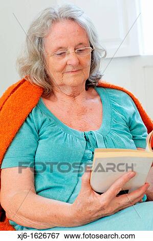 Senior woman reading a book View Large Photo Image Stock Photo - Senior woman reading a book. Fotosearch