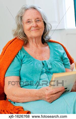 Senior woman reading a book View Large Photo Image Stock Photo - Senior woman reading a book. Fotosearch