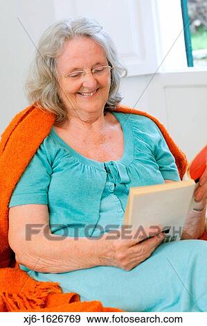 Senior woman reading a book View Large Photo Image Stock Photo - Senior woman reading a book. Fotosearch