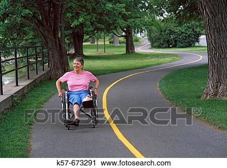Senior woman recovering in a wheelchair in a park. View Large Photo Image Stock Image - Senior woman recovering in a wheelchair in a park.. Fotosearch
