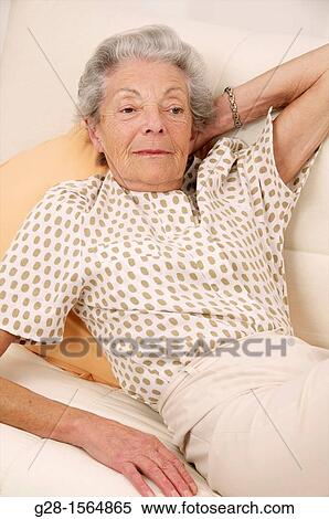 Senior woman resting on her bed at home View Large Photo Image Stock Photography - Senior woman resting on her bed at home. Fotosearch