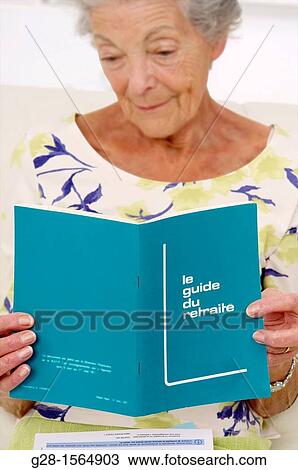 Senior woman sitting and reading instructions in a retirement guide book View Large Photo Image Stock Image - Senior woman sitting and reading instructions in a retirement guide book. Fotosearch