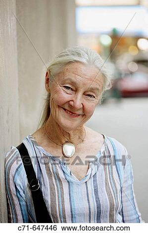 Senior woman smiling in the camera View Large Photo Image Stock Photograph - Senior woman smiling in the camera. Fotosearch