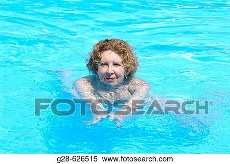 Senior woman swimming in outside pool View Large Photo Image Stock Photography - Senior woman swimming in outside pool. Fotosearch