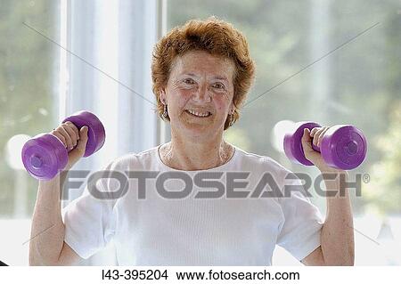 Picture - Senior woman using dumbbells. Fotosearch
