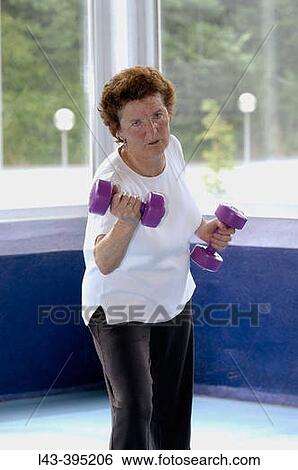 Senior woman using dumbbells View Large Photo Image Stock Photograph - Senior woman using dumbbells. Fotosearch