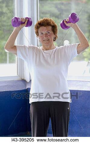 Senior woman using dumbbells View Large Photo Image Stock Photography - Senior woman using dumbbells. Fotosearch