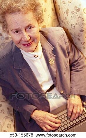Senior woman using laptop computer View Large Photo Image Stock Photo - Senior woman using laptop computer. Fotosearch