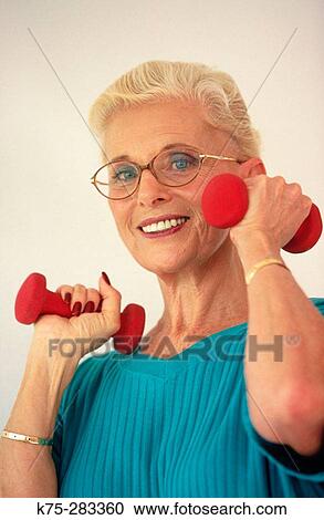 Senior woman using weights View Large Photo Image Stock Image - Senior woman using weights. Fotosearch
