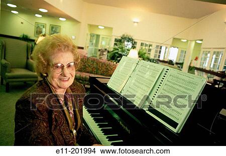 Senior woman wearing glasses at retirement home piano View Large Photo Image Picture - Senior woman wearing glasses at retirement home piano. Fotosearch