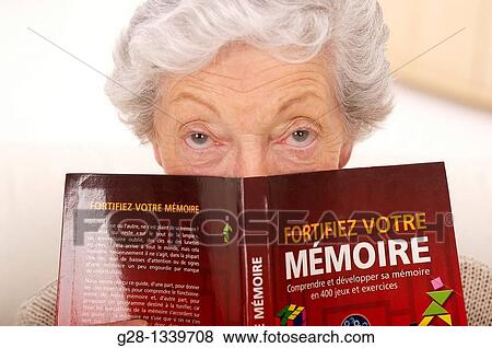 senior woman with a book on how to exercise memory View Large Photo Image Stock Photo - senior woman with a book on how to exercise memory. Fotosearch