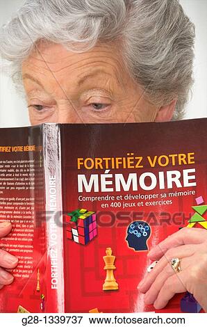senior woman with a book on how to exercise memory View Large Photo Image Stock Photo - senior woman with a book on how to exercise memory. Fotosearch