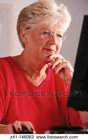Senior woman with computer View Large Photo Image Stock Image - Senior woman with computer. Fotosearch