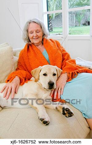 Stock Image - Senior woman with dog. Fotosearch