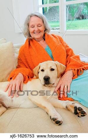 Stock Image - Senior woman with dog. Fotosearch