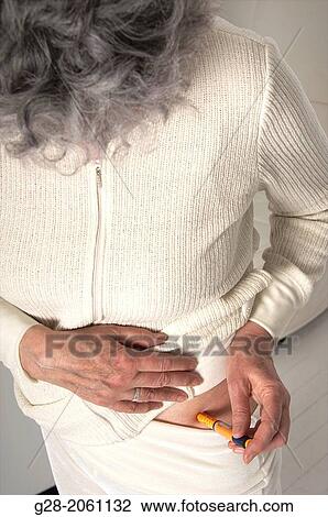 Senior woman with grey hair seen from above, using an insulin lancet for Diabetes View Large Photo Image Stock Image - Senior woman with grey hair seen from above, using an insulin lancet for Diabetes. Fotosearch