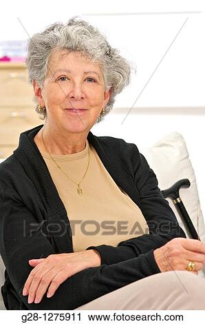 senior woman with grey hair, sitting at home, inside, and holding her walking stick View Large Photo Image Stock Image - senior woman with grey hair, sitting at home, inside, and holding her walking stick. Fotosearch