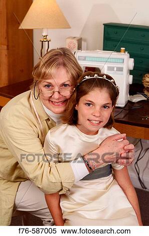 Senior woman working at sewing machine, hugging her granddaughter. View Large Photo Image Stock Photography - Senior woman working at sewing machine, hugging her granddaughter.. Fotosearch