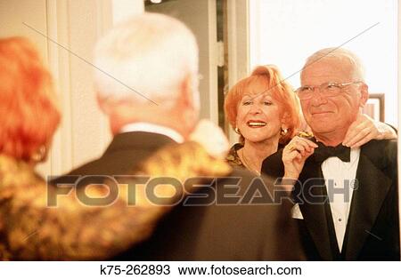 Stock Image - Seniors getting ready for a party. Fotosearch