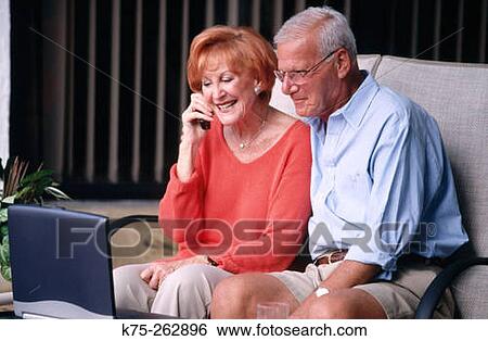 Seniors on phone with laptop View Large Photo Image Stock Photograph - Seniors on phone with laptop. Fotosearch