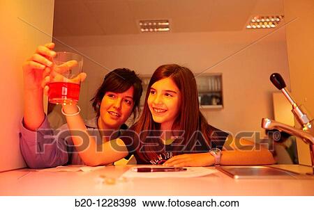 Stock Photo - Sensory analysis specialist helping girl during a soft drink tasting session in lab, AZTI-Tecnalia Marine and Food Research Center, Derio, Bizkaia, Euskadi, Spain. Fotosearch