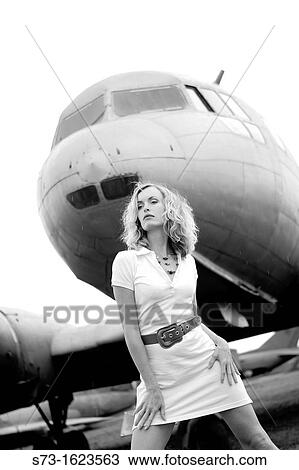 Sensual woman next to a plane View Large Photo Image Stock Image - Sensual woman next to a plane. Fotosearch