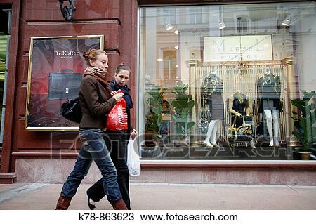 Stock Image - Sep 2008 - Women walking by a shop along Nikolskaya Ulitsa street, Moscow, Russia. Fotosearch