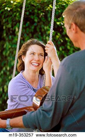 Stock Photo - serenade on a swing. Fotosearch