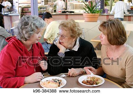 Stock Photo - Seriors sharing a meal. Fotosearch
