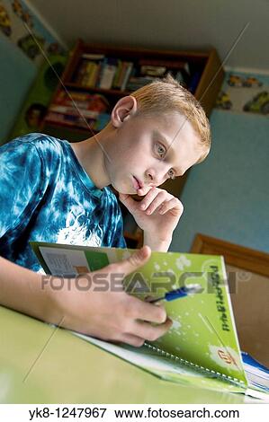 Serious Teenage Boy Sitting at Home Desk and Learning View Large Photo Image Stock Photo - Serious Teenage Boy Sitting at Home Desk and Learning. Fotosearch
