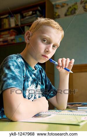 Serious Teenage Boy Sitting at Home Desk and Learning View Large Photo Image Stock Photo - Serious Teenage Boy Sitting at Home Desk and Learning. Fotosearch