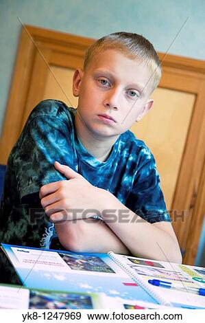 Serious Teenage Boy Sitting at Home Desk and Learning View Large Photo Image Stock Photo - Serious Teenage Boy Sitting at Home Desk and Learning. Fotosearch