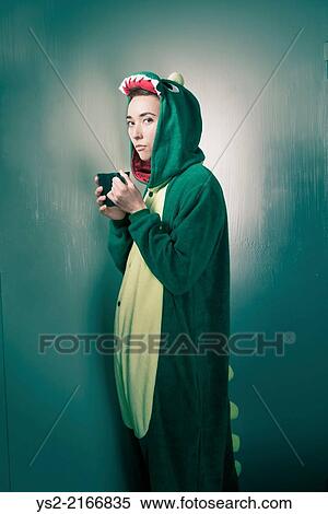 Serious woman in dinosaur costume drinking coffee on a break. View Large Photo Image Stock Photography - Serious woman in dinosaur costume drinking coffee on a break.. Fotosearch