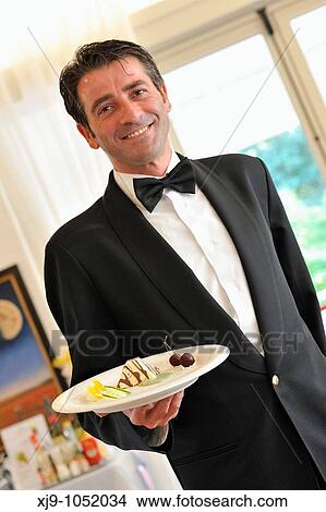 Serving waiter brings the dessert View Large Photo Image Picture - Serving waiter brings the dessert. Fotosearch