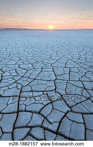 Setting sun on patterns of cracked mud on dry lakebed of Harney Lake, Malheur National Wildlife Refuge, Oregon View Large Photo Image Stock Photo - Setting sun on patterns of cracked mud on dry lakebed of Harney Lake, Malheur National Wildlife Refuge, Oregon. Fotosearch