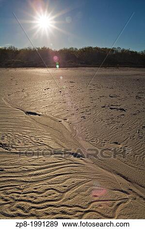 Setting sun over textures in the sand near a salt lake, Texas, United States. View Large Photo Image Stock Photo - Setting sun over textures in the sand near a salt lake, Texas, United States.. Fotosearch