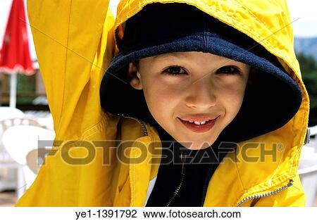 Stock Image - Seven year old boy looking at the camera and smiling. Fotosearch