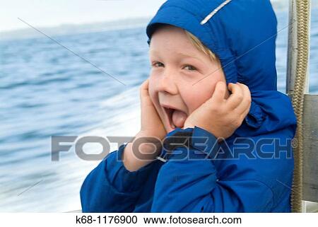 Stock Image - seven year old boy on boat trip from Flores Island to Tofino, West Coast, Vancouver Island, British Columbia, Canada. Fotosearch