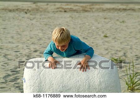 seven year old boy playing on beach, West Coast, Vancouver Island, British Columbia, Canada View Large Photo Image Stock Photo - seven year old boy playing on beach, West Coast, Vancouver Island, British Columbia, Canada. Fotosearch