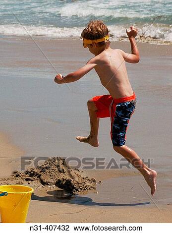 Stock Image - Seven years old child jumping. Dana Point, California. USA.. Fotosearch
