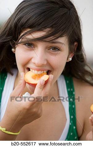 Seventeen year old girl eating fruit. View Large Photo Image Stock Photo - Seventeen year old girl eating fruit.. Fotosearch