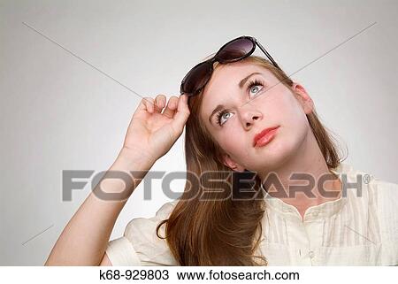 Stock Image - seventeen year old girl in studio portrait, with sunglasses. Fotosearch