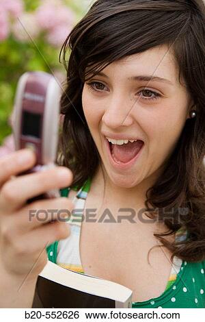 Seventeen year old girl reading a message View Large Photo Image Stock Photograph - Seventeen year old girl reading a message. Fotosearch